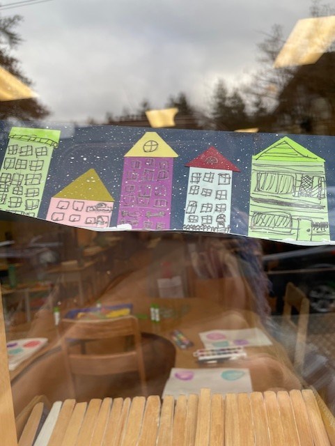 Div 9 hints at winter with jellybean row house art.